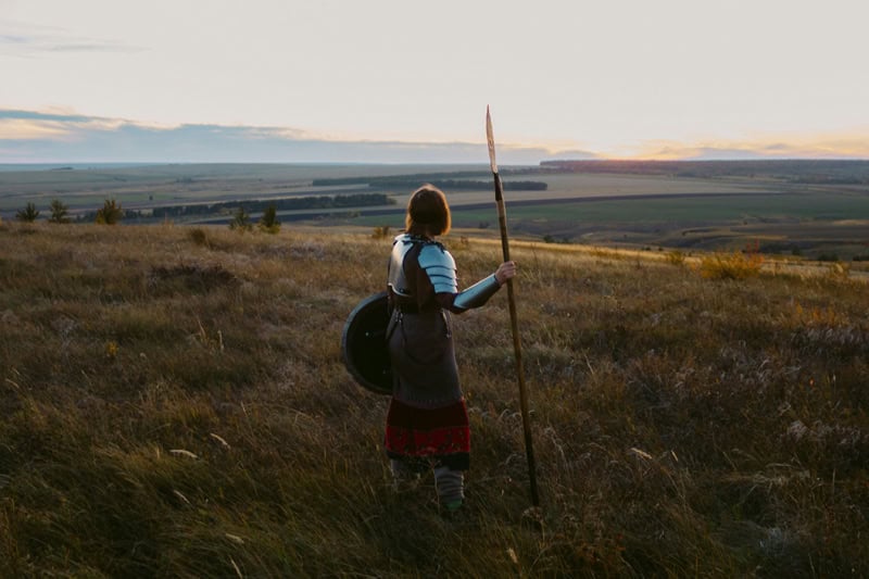 a man in a field with a spear