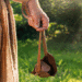 a hand holding a slingshot