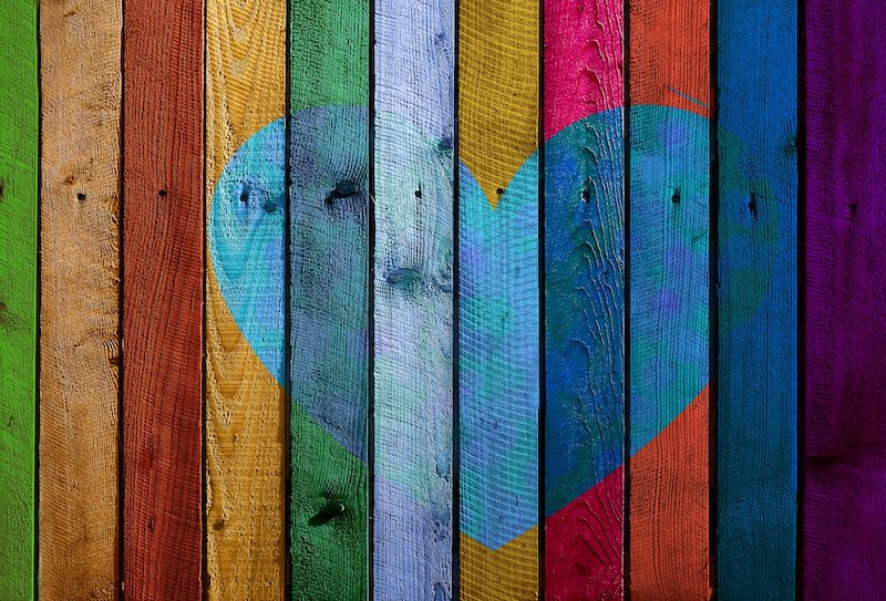 a painted colorful heart on a fence
